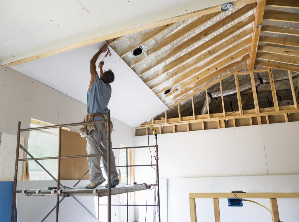 image of man drywalling a home