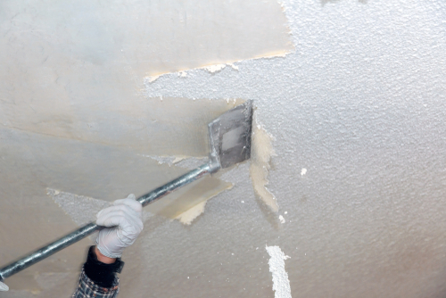 image of man scraping drywall texture